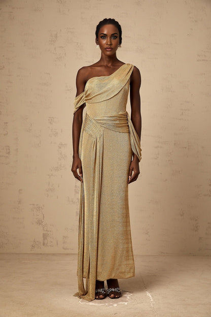 A long flowing golden maxi dress with gathered fabric and ribbon design details