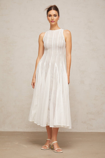 A white midi dress with pointelle detailing and puff sleeves named Helene