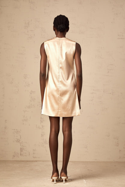 A short white mini dress with intricate embroidery and beaded embellishments featuring a fitted silhouette and delicate design details