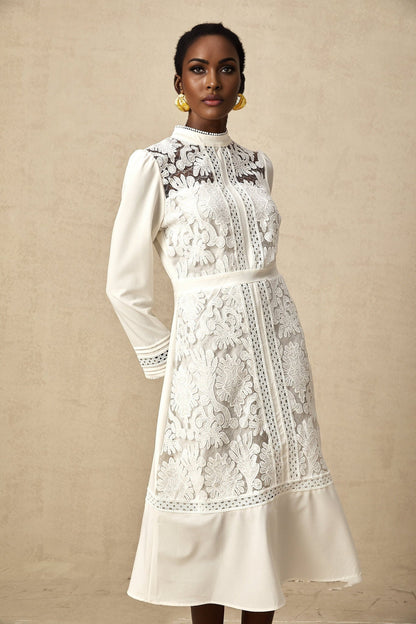 A white midi dress with panelled design and embroidery details named Madeleine featuring a fitted silhouette and feminine aesthetic