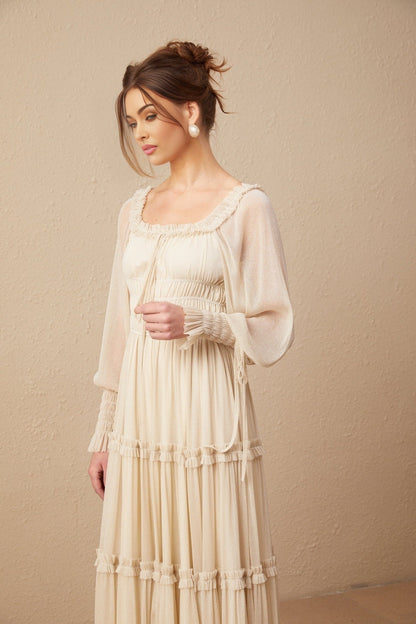 Woman wearing a pleated metallic midi dress with shirred detailing and a flowy silhouette named Camille