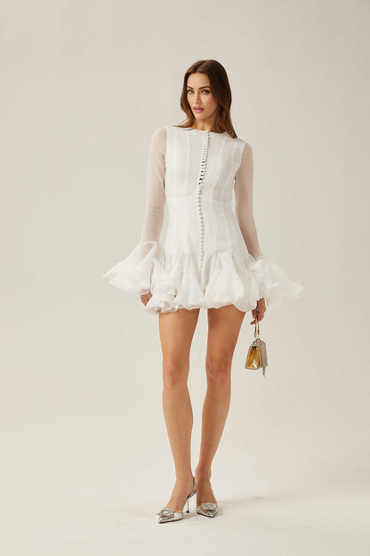 Woman wearing a short flared dress with semi sheer fabric in flowy silhouette