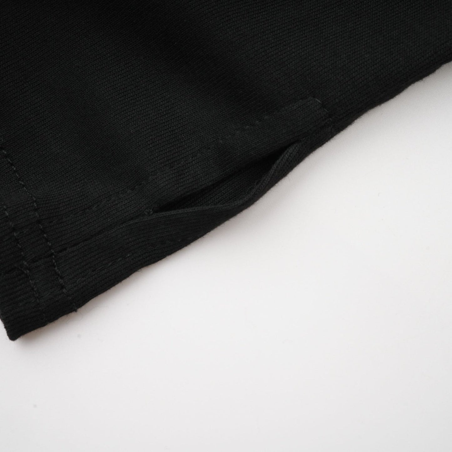 Woman wearing a black sleeveless top with ruched detailing and stretchy fabric