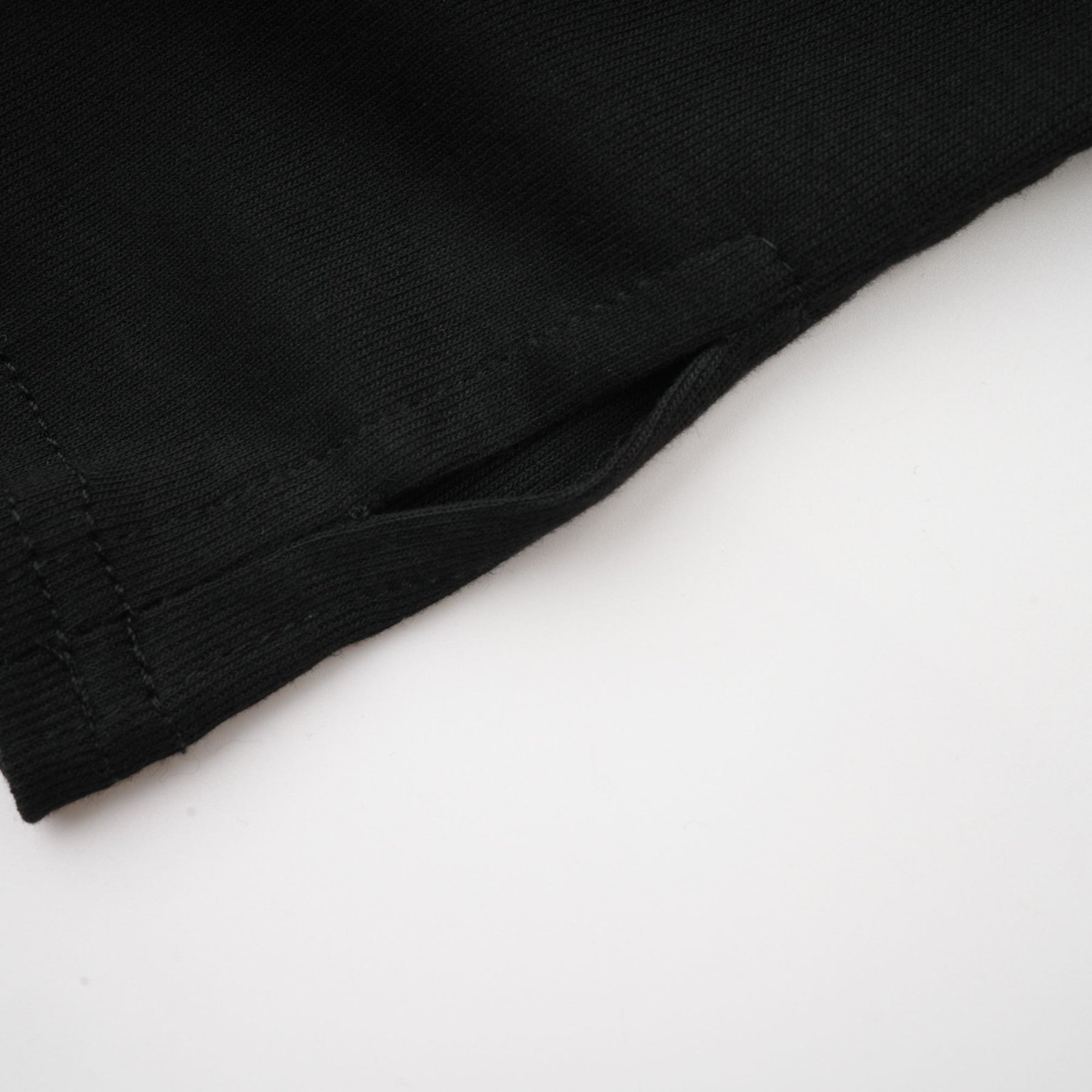 Woman wearing a black sleeveless top with ruched detailing and stretchy fabric