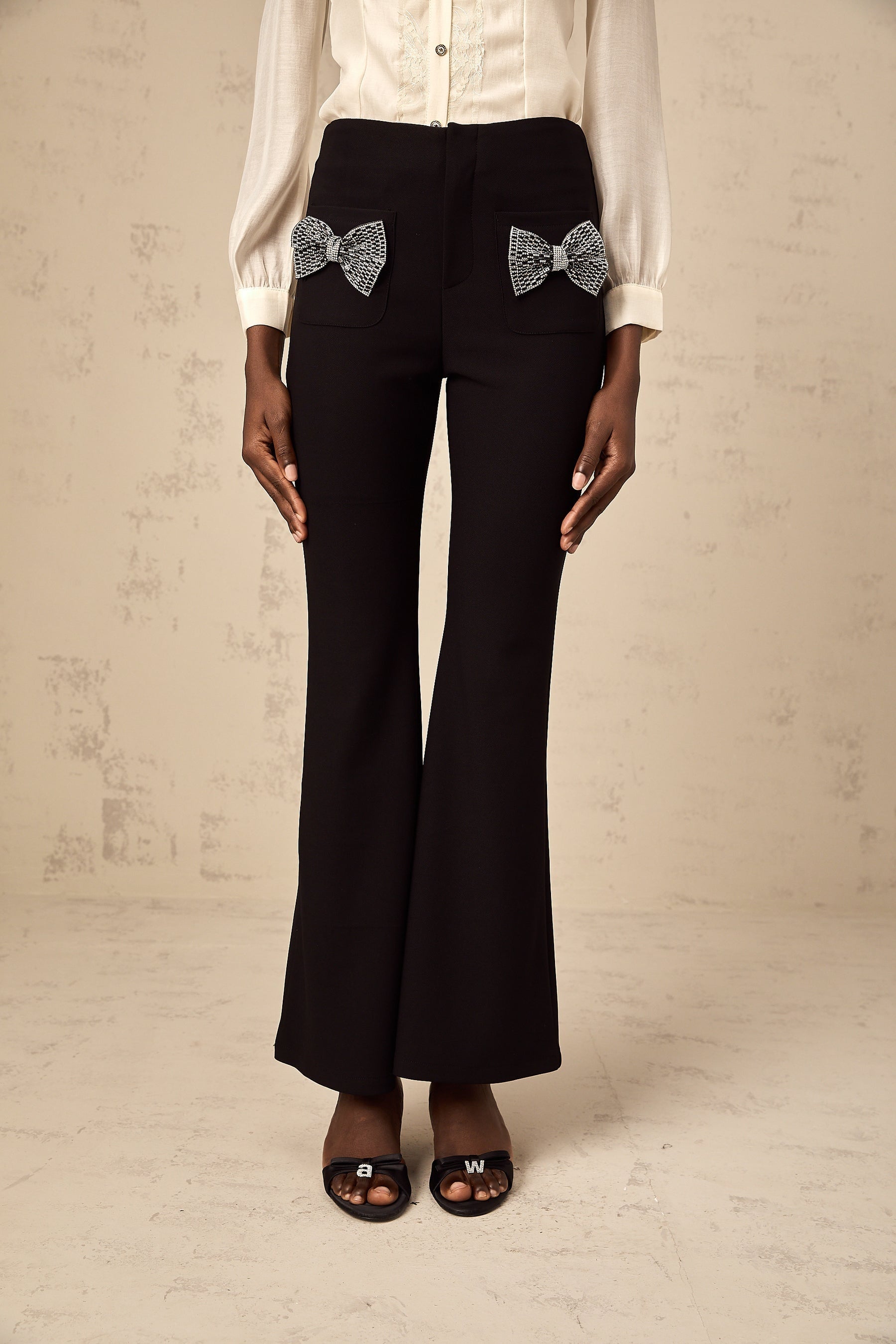 Flared trousers with a decorative bow detail named Gelsomina