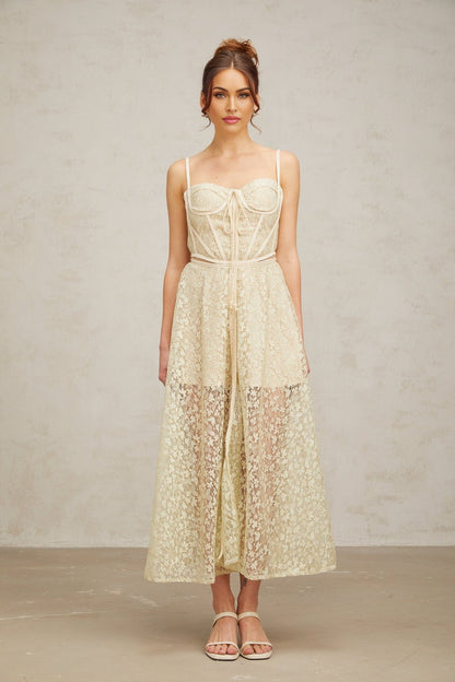A light green midi dress with floral embroidery details named Yasmine