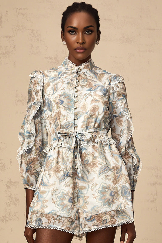 A blue floral print jumpsuit with ruffles and lace trim details named Eugenie