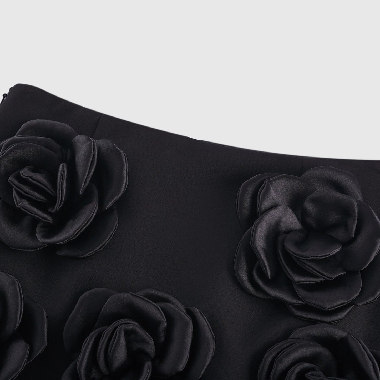 Black mini skirt with artificial flowers by Nalini
