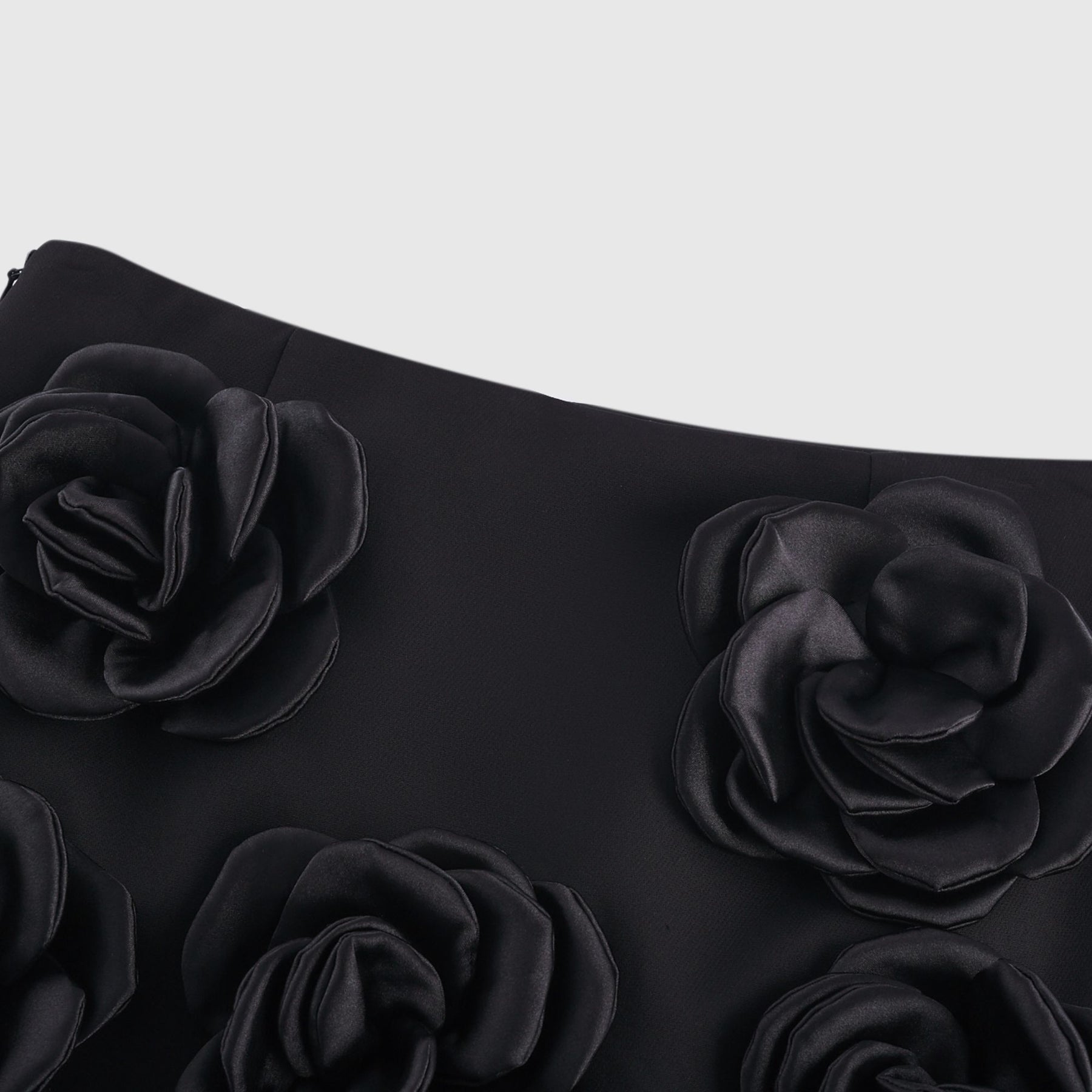 Black mini skirt with artificial flowers by Nalini