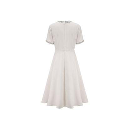 White midi dress with crystal accents and bow detail named Cassiopeia