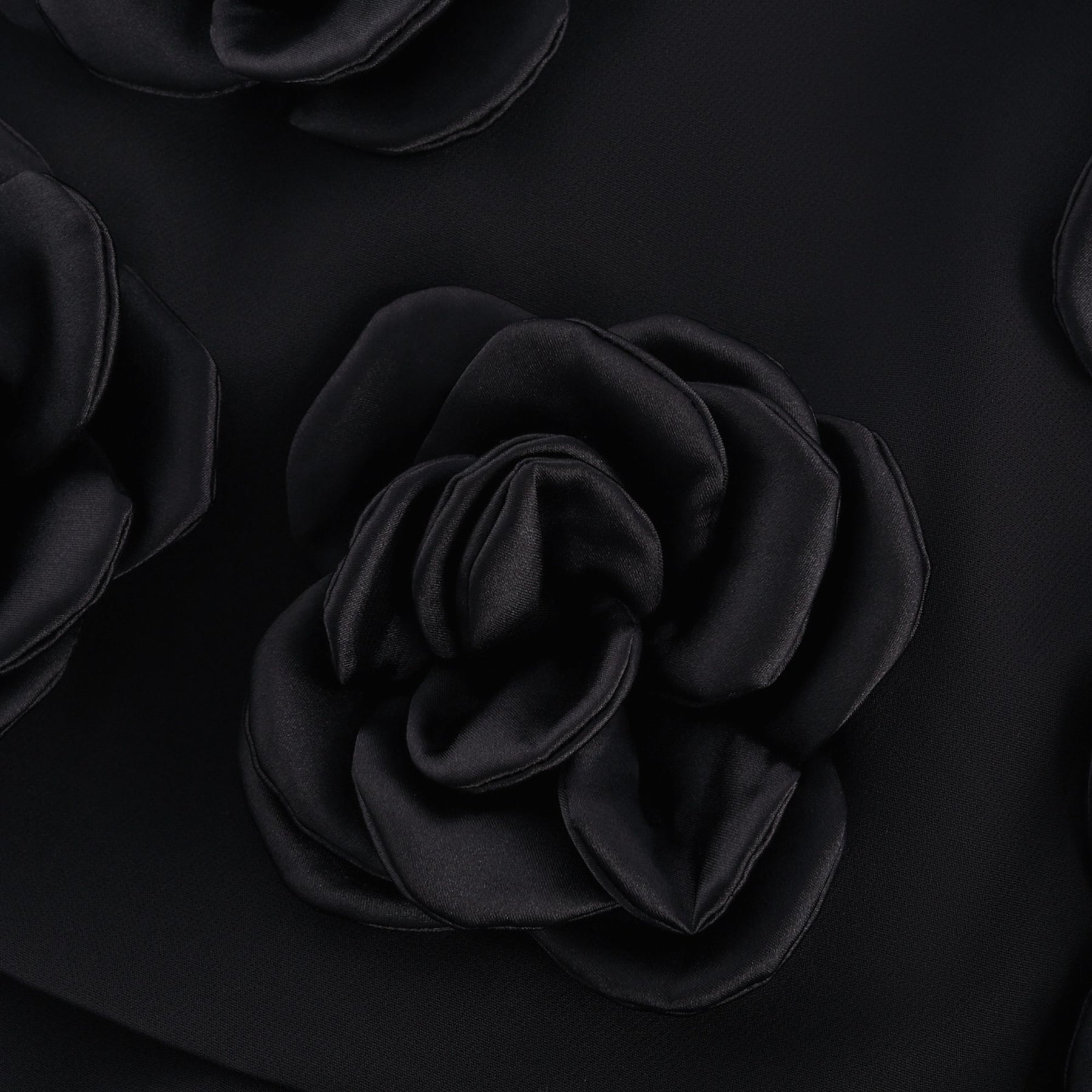 Black mini skirt with artificial flowers by Nalini