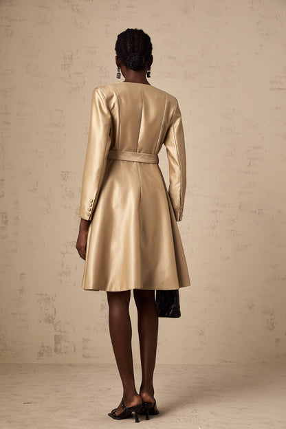 Woman wearing long khaki coat with belt at waist and open front