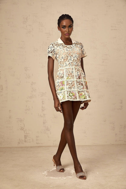 A short floral mini dress with embroidered flower details and a feminine silhouette