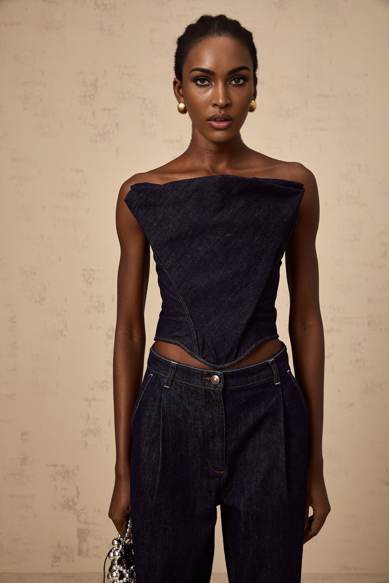 A dark blue offshoulder denim top with the brand name Kleber