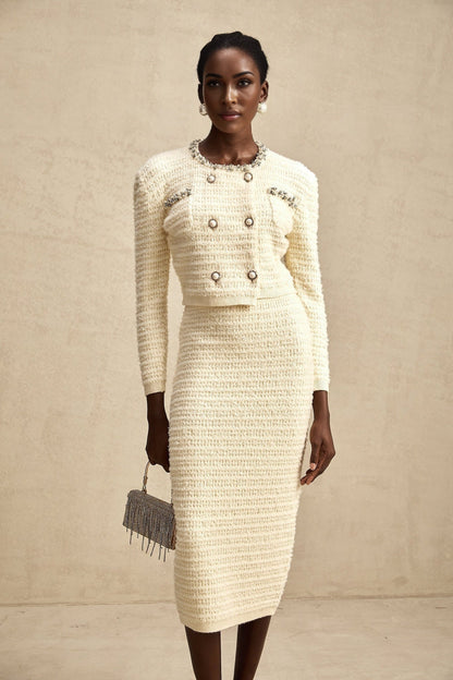 A matching set featuring a knit cardigan and skirt with embellishments called Justine The cardigan and skirt are coordinated in style and color creating a cohesive outfit