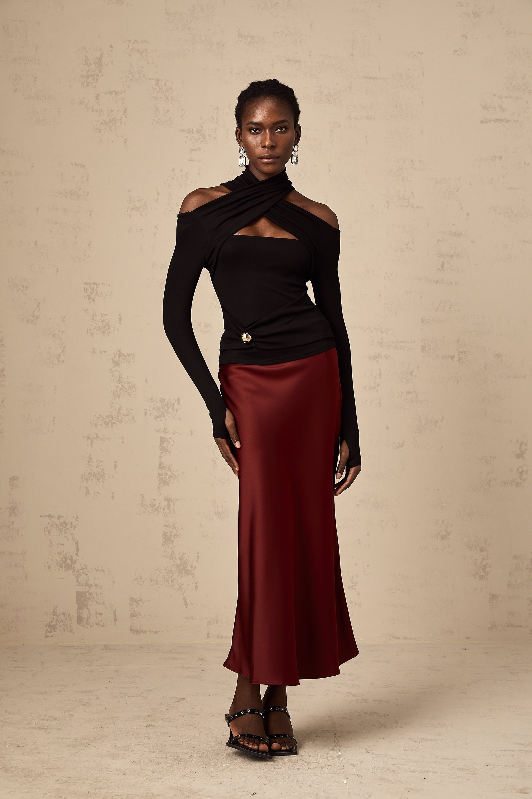 Red satin skirt with flared silhouette shown on white background