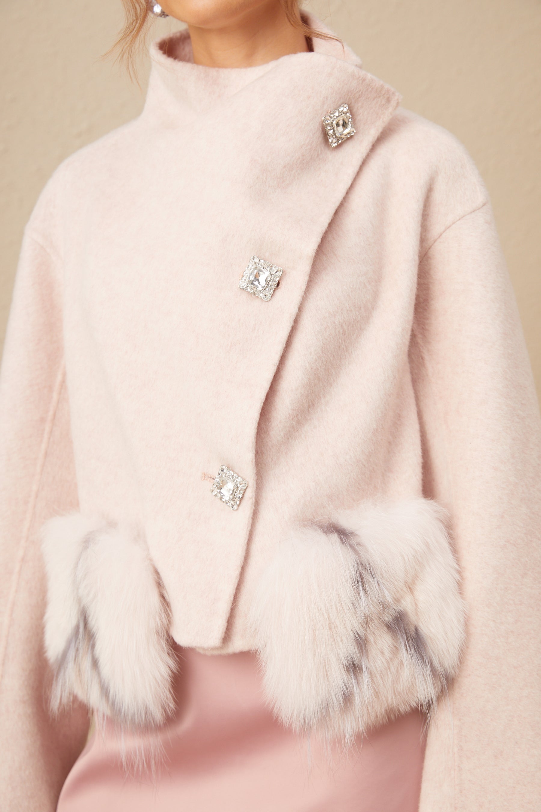 A short pink coat with a diagonal placket closure and a stylish design named Vienne