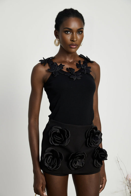 Black mini skirt with artificial flowers by Nalini