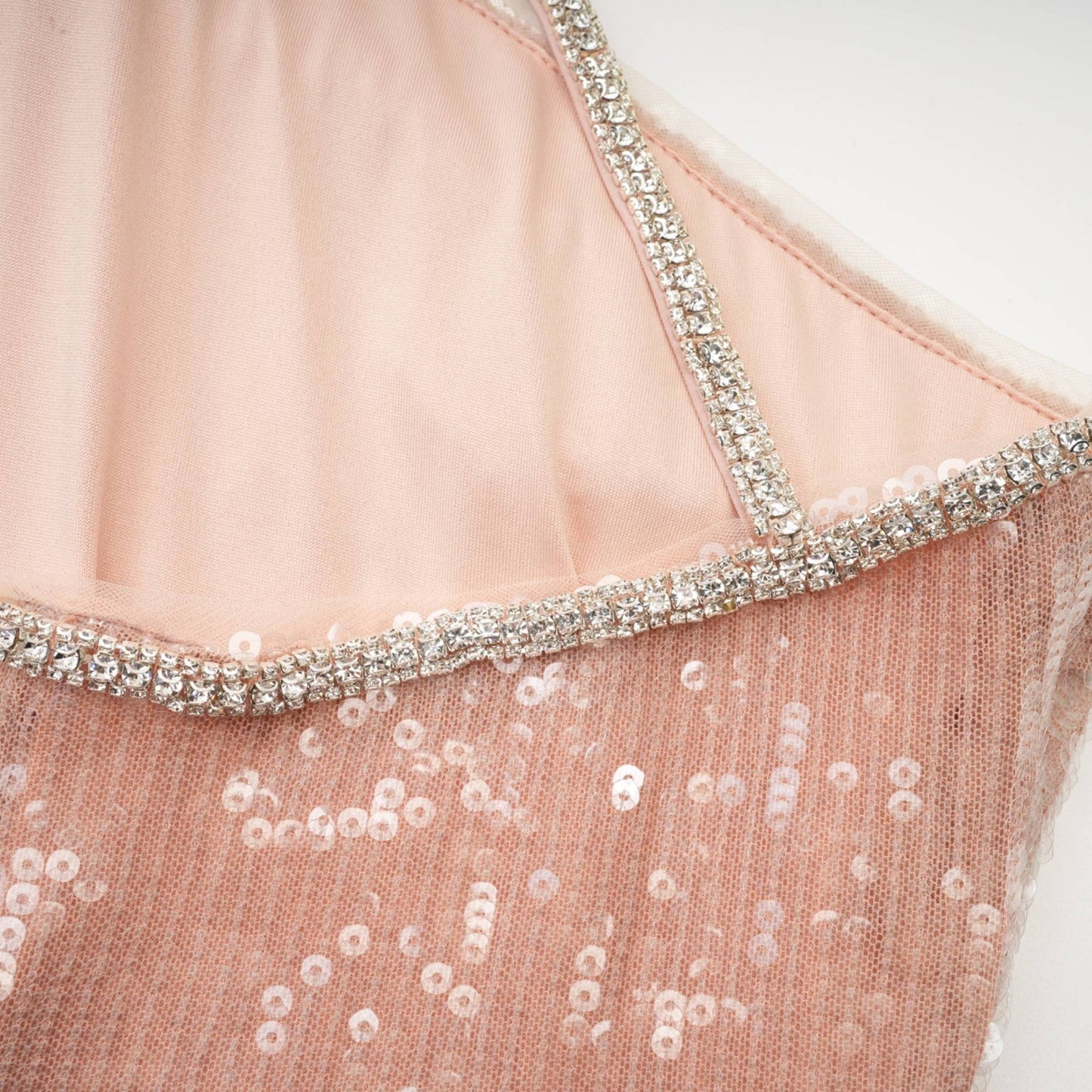 Woman wearing a short sparkly dress with floral sequin pattern
