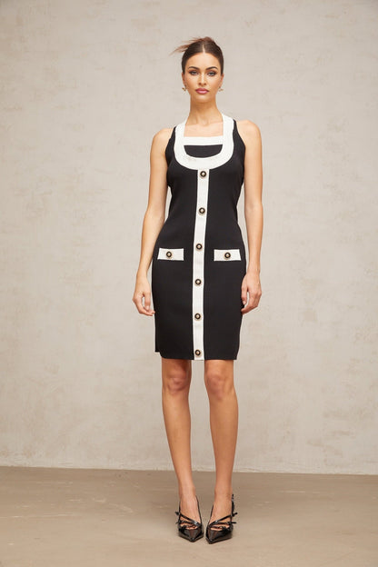 A sleeveless knit mini dress with a halter neckline featuring color blocks in different shades The dress has a form fitting silhouette and falls above the knee