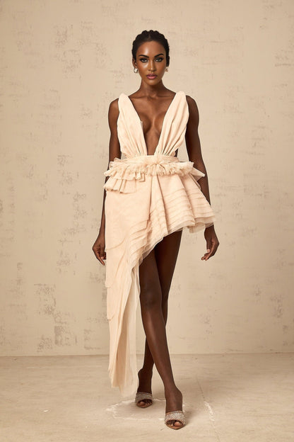 A beige asymmetric mini dress with ribbon design details and a flattering silhouette featuring neutral tones