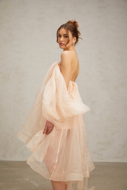A short voluminous mini dress with bow details and a feminine silhouette named Elodie