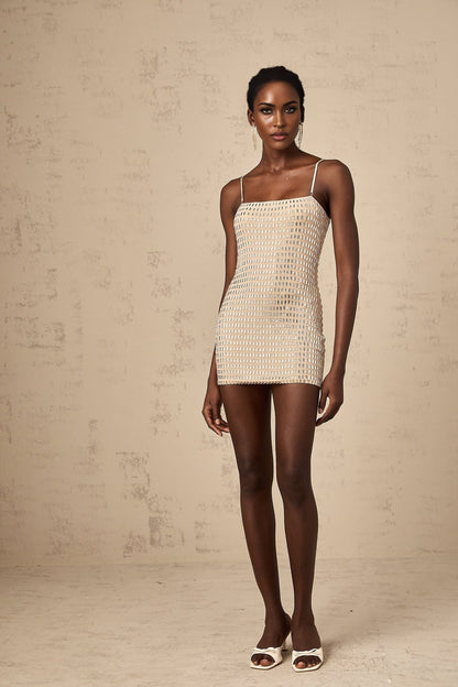 A short black mini dress with metallic stud embellishments adorning the fabric creating a textured and eyecatching design