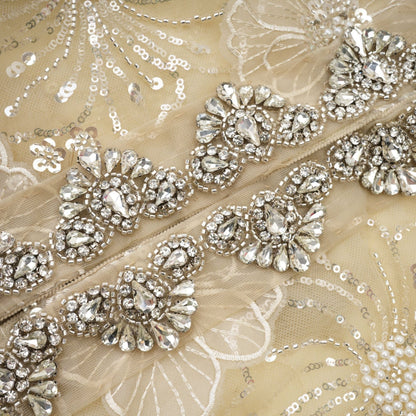 Woman wearing a semi sheer floral jacket with beaded details and organza fabric in a luxurious style