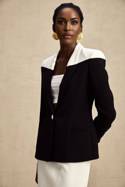 A matching set featuring a jacket and skirt in contrasting colors by Honorine