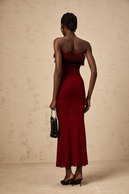 A red offshoulder midi dress with faux fur trim and mesh details featuring a formfitting silhouette