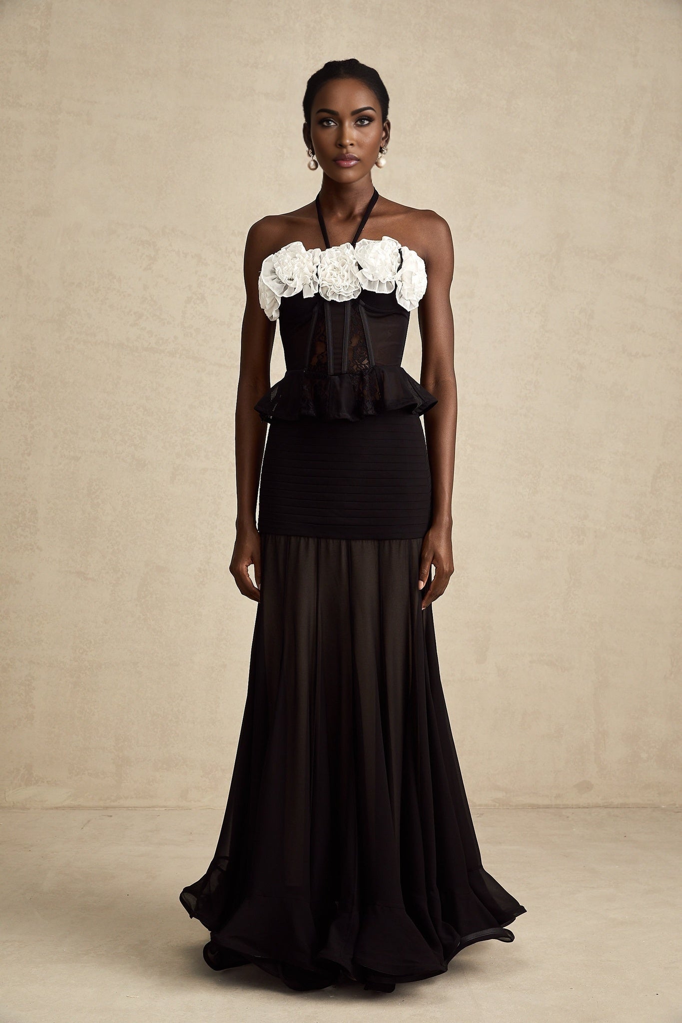 A black corset top with faux flower lace detailing featuring a fitted silhouette and sweetheart neckline