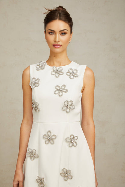 A short white mini dress with a floral pattern made of crystal embellishments covering the fabric named Coralie