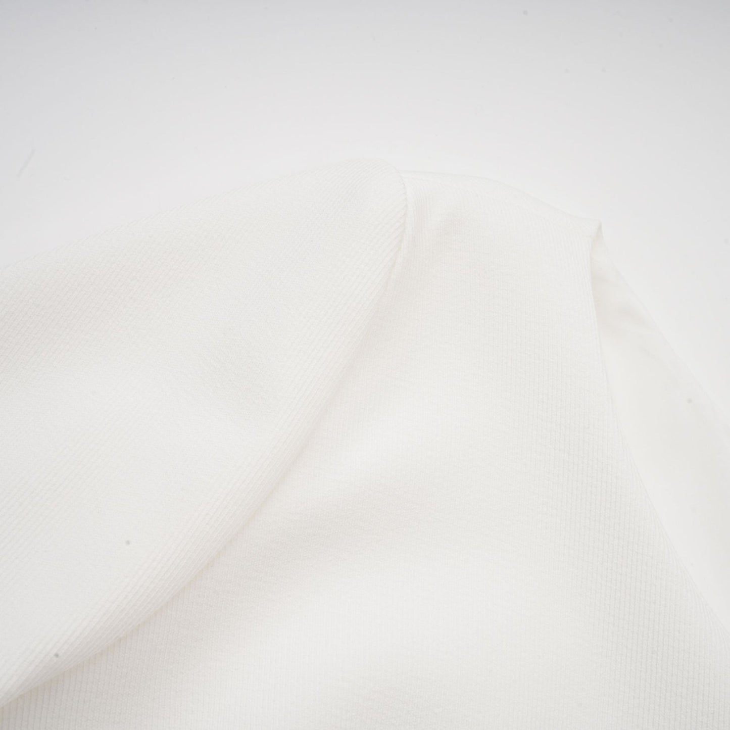 A white mini dress with a bubble skirt named Elodie featuring a fitted bodice and voluminous short skirt