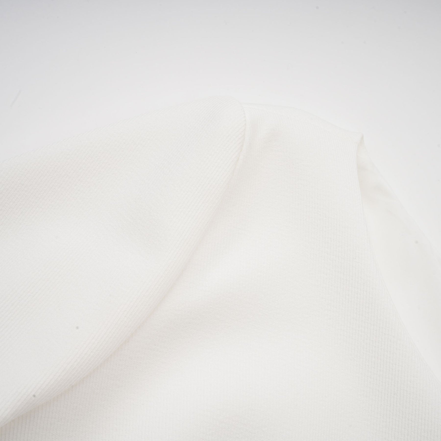 A white mini dress with a bubble skirt named Elodie featuring a fitted bodice and voluminous short skirt