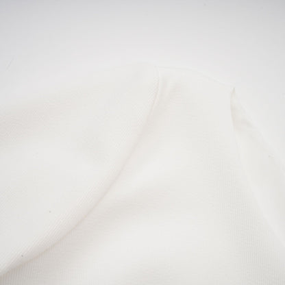 A white mini dress with a bubble skirt named Elodie featuring a fitted bodice and voluminous short skirt