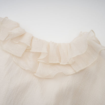 Tiered mini dress in neutral tones with floral applique detailing named Zephyrine