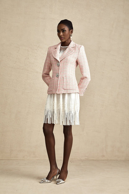 A pink blazer with crystal embellishments and a checked tweed pattern