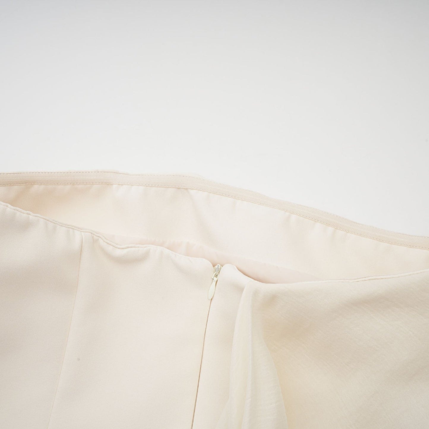 A flared mini dress with ribbon design details called Danae featuring a short hemline and decorative ribbon elements on the fabric