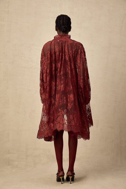 A red oversize dress made of Coline chantilly lace with a flowing silhouette and delicate floral patterns