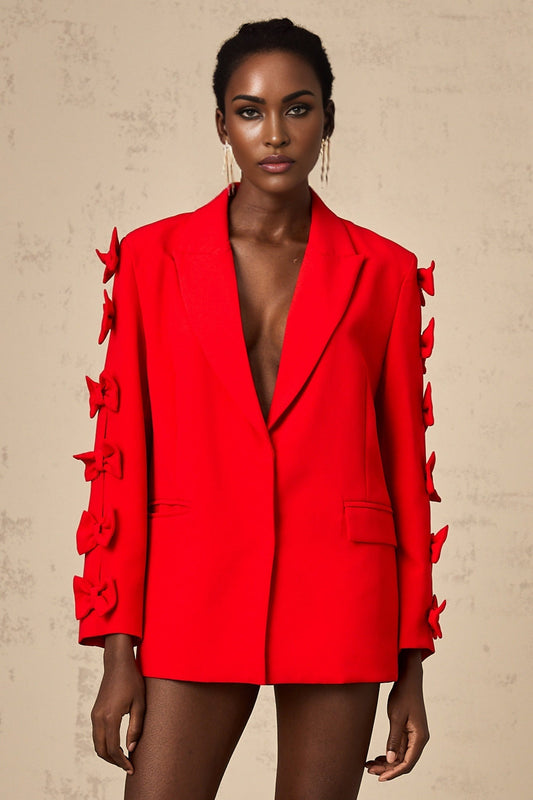 A red blazer with a bow detail and cutout design featuring a tailored fit and feminine silhouette
