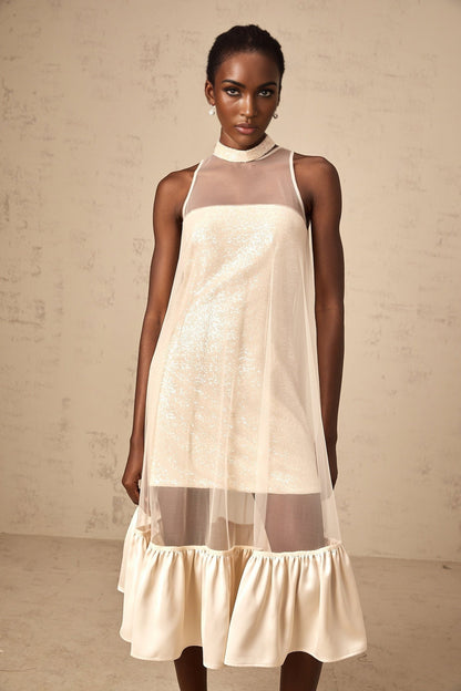 A midi dress with a layered tulle panel and sequin embellishments featuring a combination of sheer and sparkly elements in an elegant silhouette