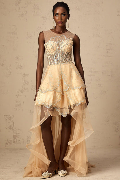 Woman wearing long champagne colored gown with daisy embellishments and high low hemline