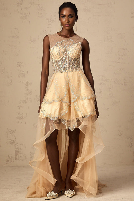 Woman wearing long champagne colored gown with daisy embellishments and high low hemline