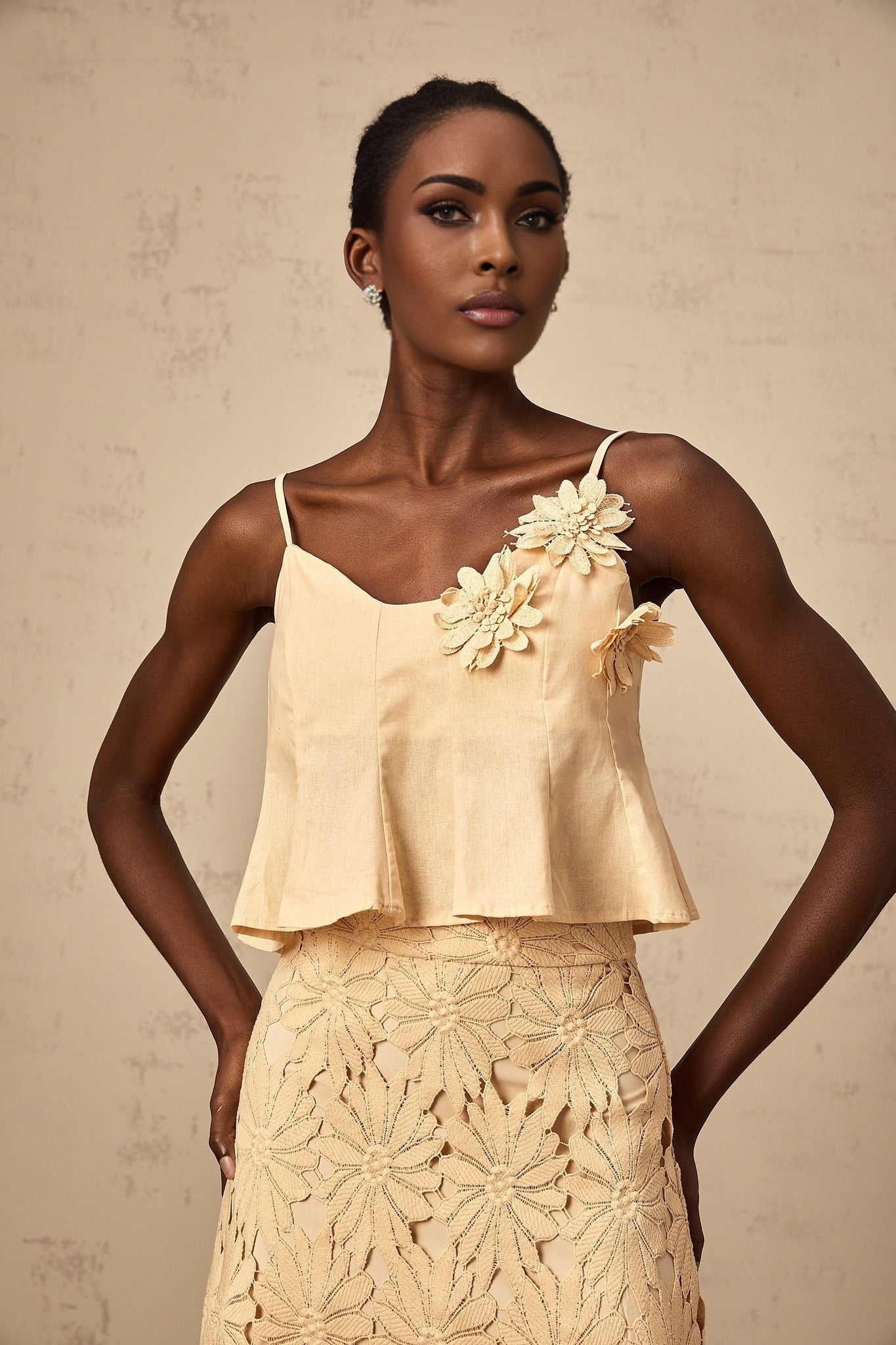 A khaki colored matching set from Celine featuring a top with cutout details and a flared skirt