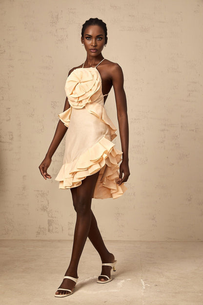 A short pink mini dress with threedimensional petallike ruffles covering the entire garment creating a floral textured appearance