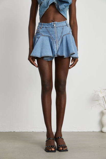 A denim skirt with a ruffled hem named Capucine Denimrock featuring a volant bottom edge