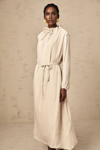 Woman wearing a light pastel tulle midi dress with self tie waist and flowy skirt
