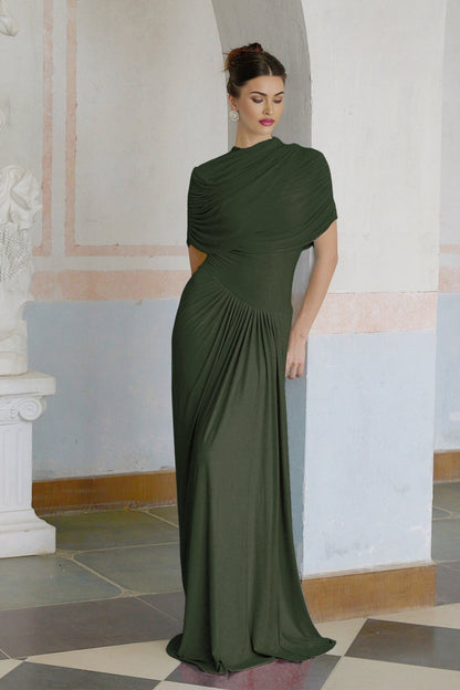 A green asymmetric maxi dress with pleated details and a long flowing skirt