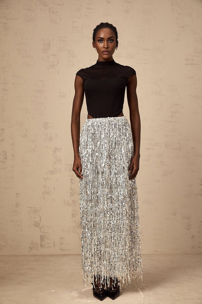 Woman wearing a twotone corset style top and matching skirt set in black and white colors