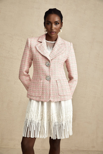 Woman wearing pink crystal embellished tweed blazer with check pattern